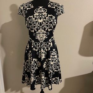 A woman’s navy blue asymmetrical dress